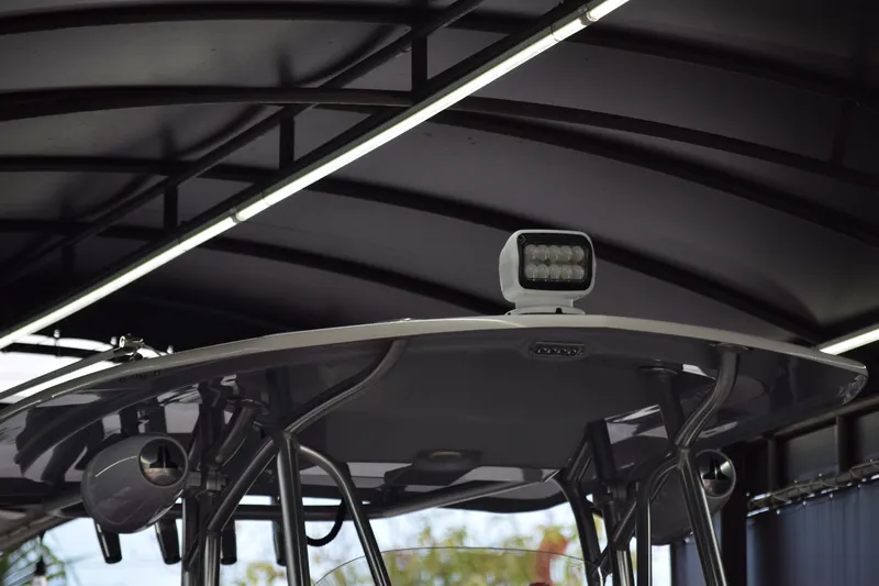 Slide: The Image of 2022 Aquasport 2300 Center Console boat with T-top and mounted spotlight. - 11