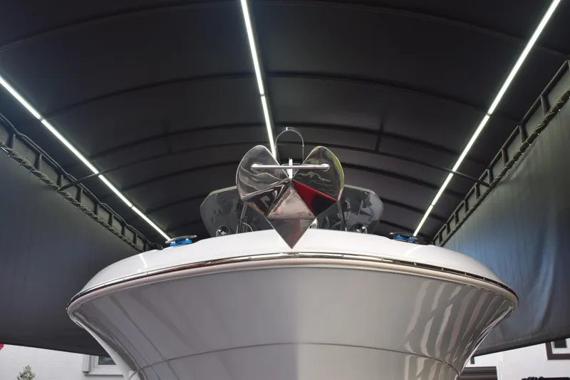 Slide: The Image of 2022 Aquasport 2300 Center Console boat in a covered storage area. - 7