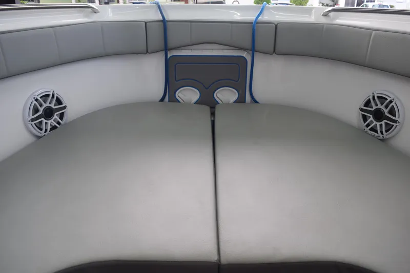 Slide: The Image of 2022 Aquasport 2300 Center Console boat interior with cushioned seating and speakers. - 28