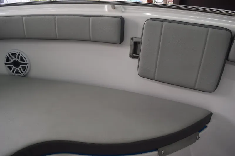 Slide: The Image of 2022 Aquasport 2300 Center Console interior with cushioned seating and speaker. - 29