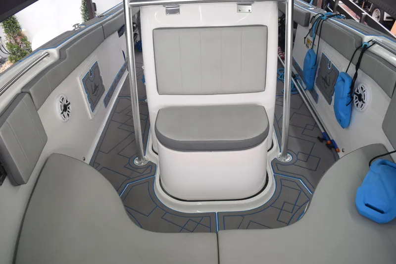 Slide: The Image of 2022 Aquasport 2300 Center Console boat interior with gray seating and blue accents. - 53