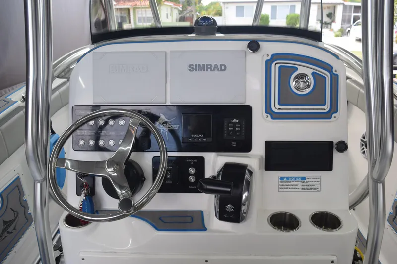 Slide: The Image of 2022 Aquasport 2300 Center Console dashboard with steering wheel and controls. - 51