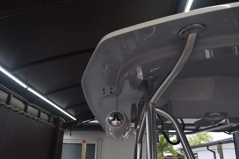 Slide: The Image of 2022 Aquasport 2300 Center Console boat under a covered structure. - 65