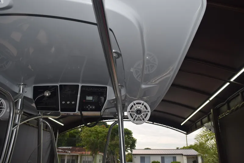 Slide: The Image of 2022 Aquasport 2300 Center Console boat interior with speakers and control panel. - 48