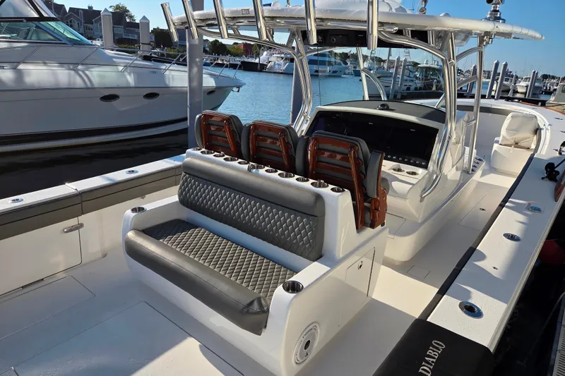 Slide: The Image of 2021 Valhalla Boatworks V-41 luxury boat interior at marina, featuring sleek seating and helm. - 26