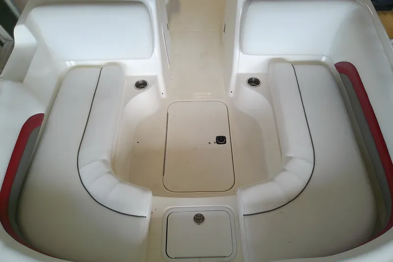 Slide: The Image of 2012 Hurricane SunDeck 217 OB boat interior with white seating and red accents. - 22