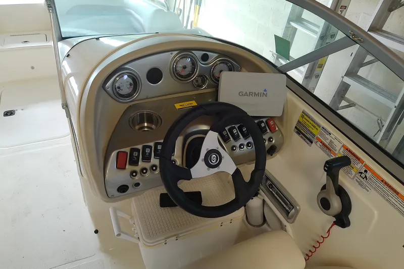 Slide: The Image of 2012 Hurricane SunDeck 217 OB boat dashboard with Garmin navigation system and steering wheel. - 29