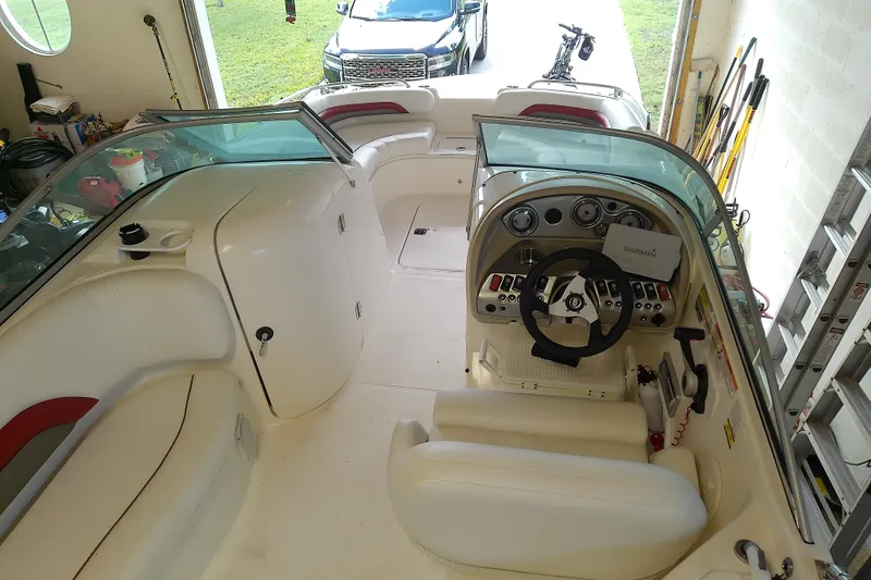 Slide: The Image of Interior view of a 2012 Hurricane SunDeck 217 OB boat with steering console and seating. - 19