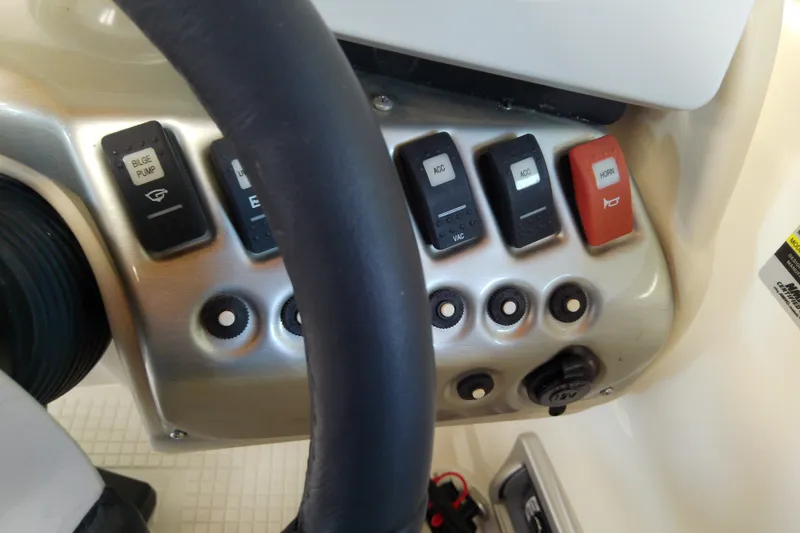 Slide: The Image of Control panel of a 2012 Hurricane SunDeck 217 OB boat with various switches. - 31