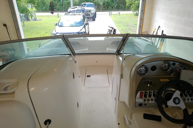 Slide: The Image of Interior view of 2012 Hurricane SunDeck 217 OB boat in a garage setting. - 34