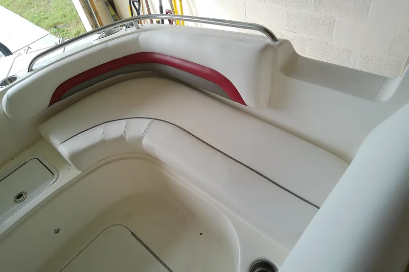 Slide: The Image of Interior seating of a 2012 Hurricane SunDeck 217 OB boat, featuring white and red upholstery. - 27