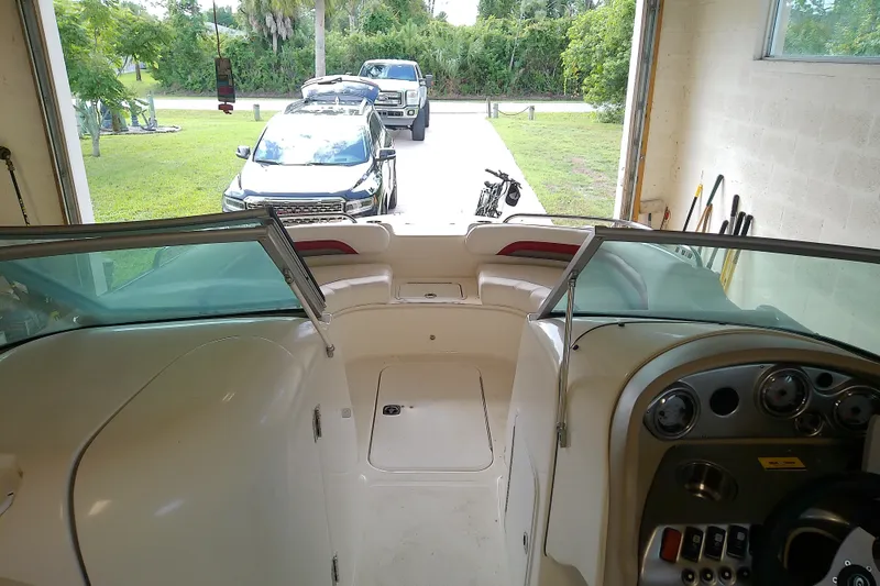 Slide: The Image of Interior view of a 2012 Hurricane SunDeck 217 OB boat in a garage setting. - 35