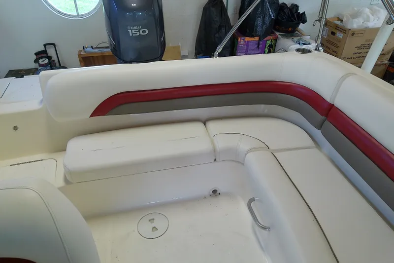 Slide: The Image of 2012 Hurricane SunDeck 217 OB boat interior with white and red seating, Yamaha 150 engine. - 24