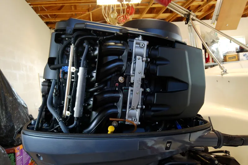 Slide: The Image of 2012 Hurricane SunDeck 217 OB outboard engine, detailed view in a garage setting. - 38