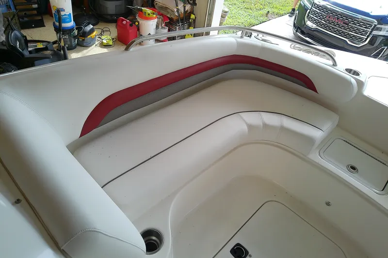 Slide: The Image of 2012 Hurricane SunDeck 217 OB boat interior with white and red seating. - 26
