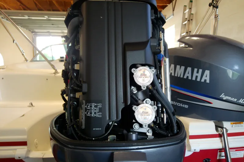 Slide: The Image of 2012 Hurricane SunDeck 217 OB with Yamaha outboard motor in a garage setting. - 39