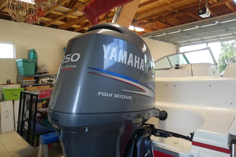 Slide: The Image of 2012 Hurricane SunDeck 217 OB with Yamaha 150 four-stroke engine in a garage. - 17