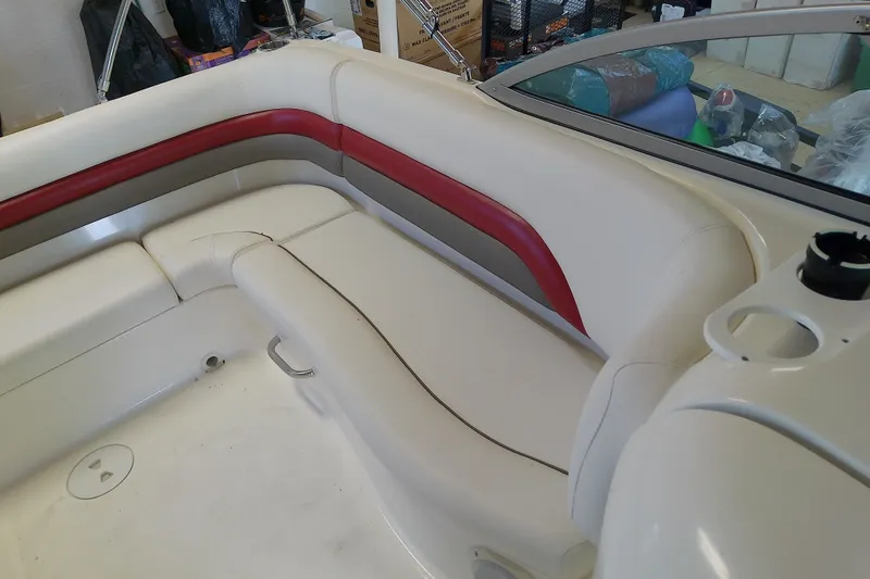 Slide: The Image of 2012 Hurricane SunDeck 217 OB boat interior with white and red seating. - 25
