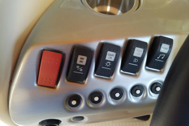 Slide: The Image of Control panel of a 2012 Hurricane SunDeck 217 OB boat with labeled switches. - 32