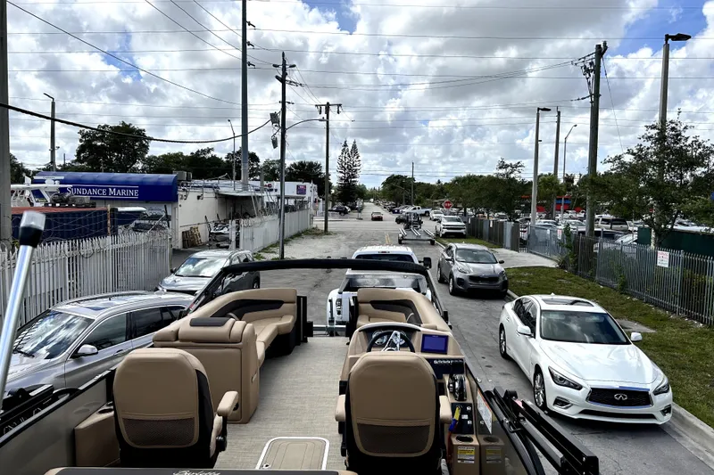 Slide: The Image of 2022 Barletta E24UC pontoon boat on trailer at Sundance Marine dealership. - 6
