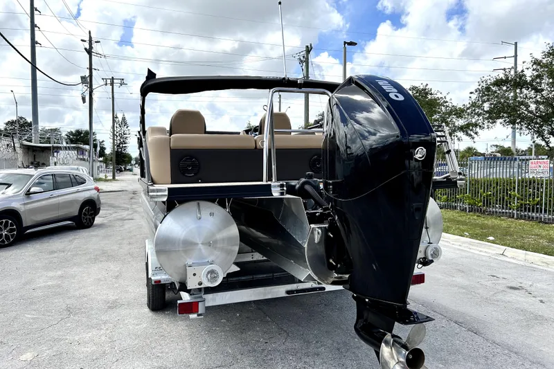Slide: The Image of 2022 Barletta E24UC pontoon boat on trailer with outboard motor. - 3