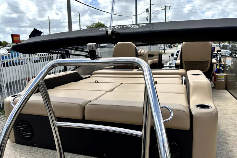 Slide: The Image of 2022 Barletta E24UC pontoon boat with beige seating and sleek design. - 5