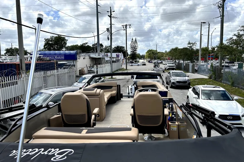 Slide: The Image of 2022 Barletta E24UC pontoon boat parked at Sundance Marine dealership. - 4