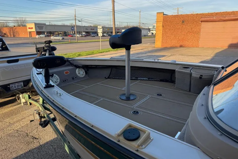 Slide: The Image of 2003 Crestliner Tournament 202 boat with fishing seat and trolling motor in parking lot. - 4