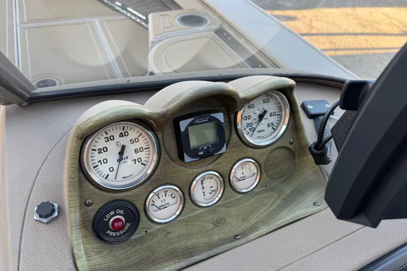 Slide: The Image of Dashboard of a 2003 Crestliner Tournament 202 SC boat with gauges and controls. - 21