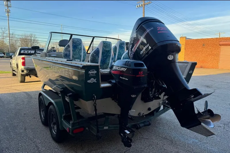 Slide: The Image of 2003 Crestliner Tournament 202 boat with Mercury outboard motors, parked on a trailer. - 1