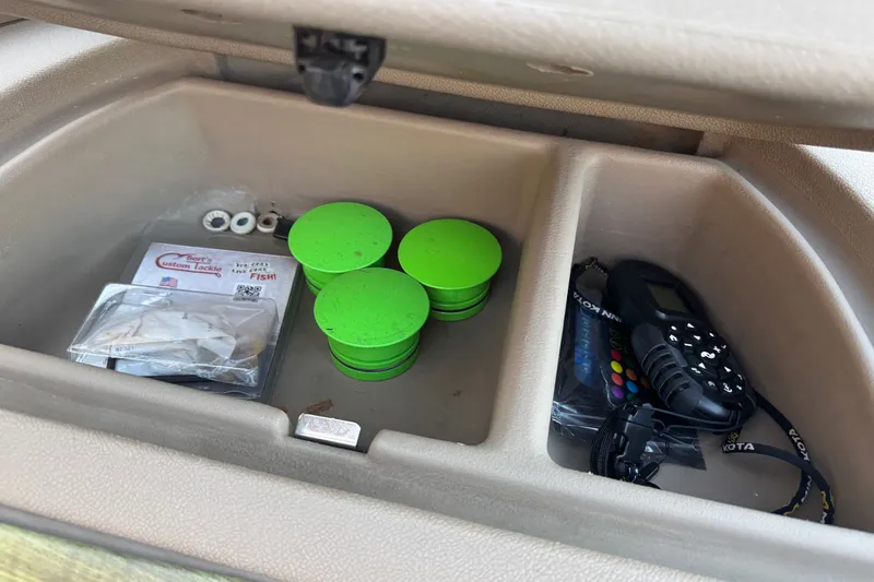 Slide: The Image of Storage compartment in 2003 Crestliner Tournament 202 SC with fishing tackle and accessories. - 18