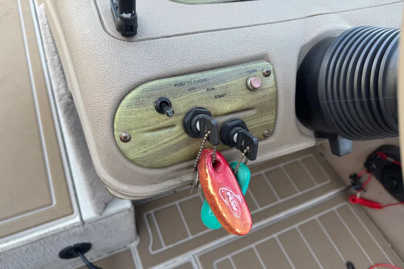 Slide: The Image of Dashboard of a 2003 Crestliner Tournament 202 SC boat with ignition keys. - 22