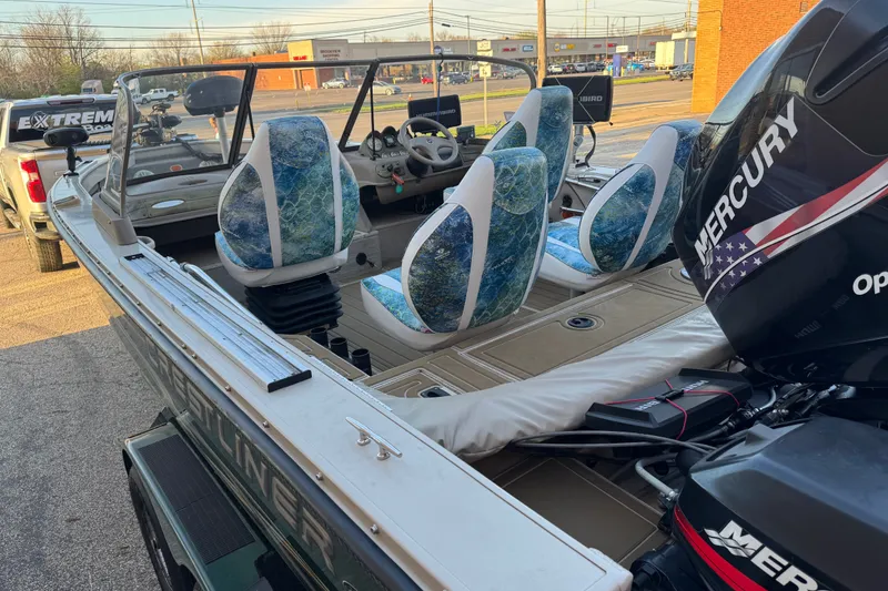 Slide: The Image of 2003 Crestliner Tournament 202 SC boat with Mercury outboard motor, parked outdoors. - 8