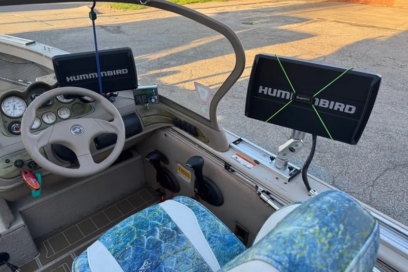 Slide: The Image of 2003 Crestliner Tournament 202 SC boat interior with Humminbird electronics and steering wheel. - 15