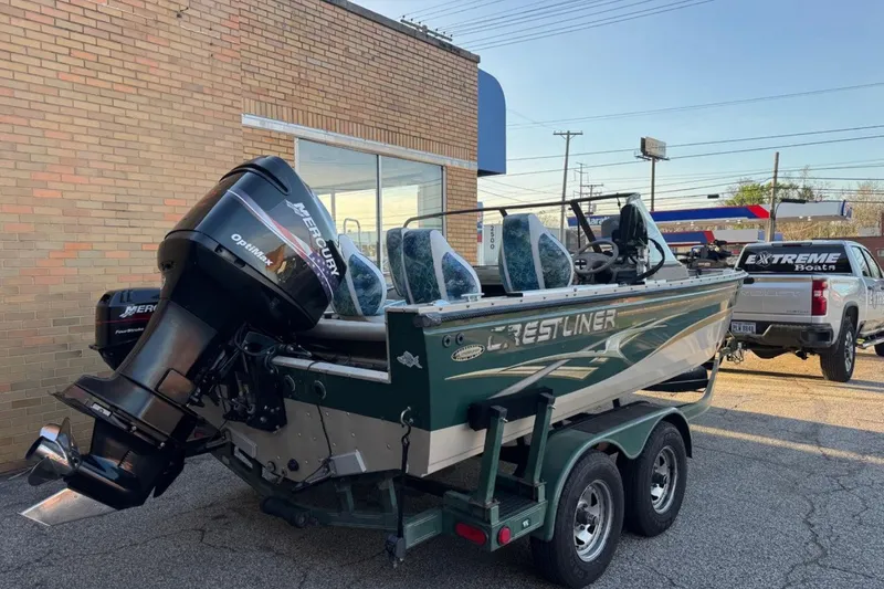 The Image of 2003 Crestliner Tournament 202 boat with Mercury Optimax engine on trailer. - 0