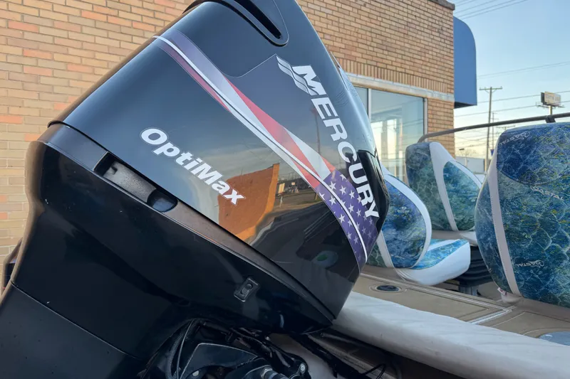 Slide: The Image of 2003 Crestliner Tournament 202 SC with Mercury OptiMax engine, parked near a brick building. - 9