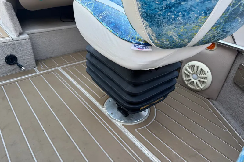 Slide: The Image of 2003 Crestliner Tournament 202 SC boat seat with blue upholstery and speaker on deck. - 14