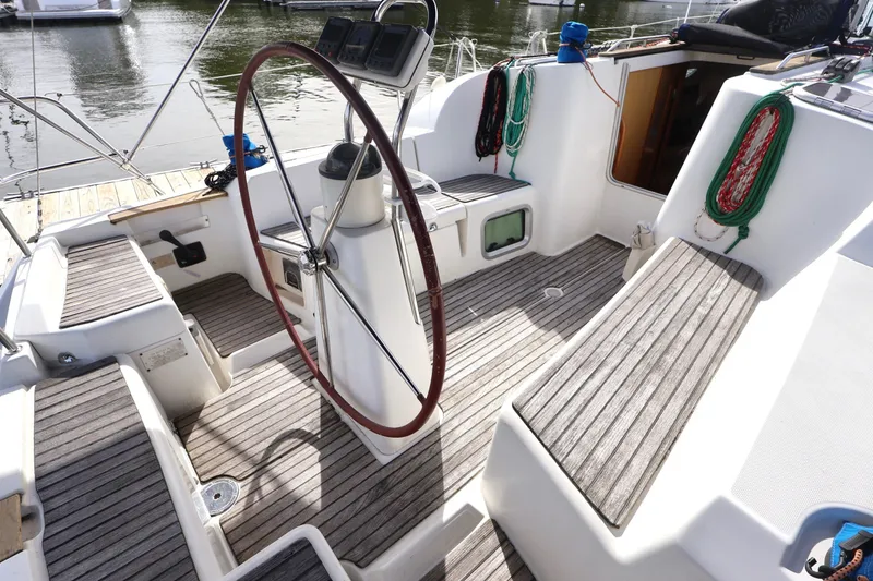 Slide: The Image of 2008 Jeanneau Sun Odyssey 36i sailboat cockpit with wooden seating and steering wheel. - 3