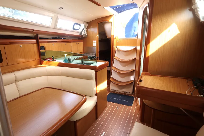 Slide: The Image of Interior of 2008 Jeanneau Sun Odyssey 36i sailboat with wood finish and seating area. - 11