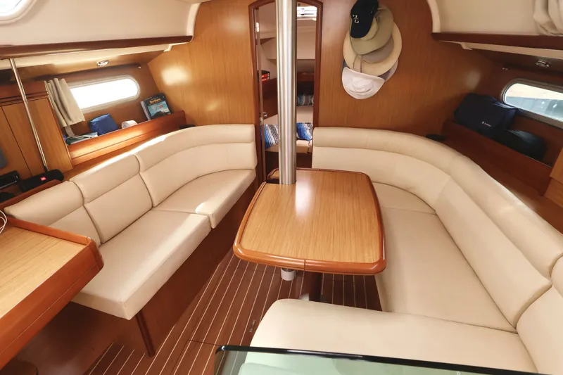 Slide: The Image of Interior of 2008 Jeanneau Sun Odyssey 36i yacht with cozy seating and wooden table. - 12