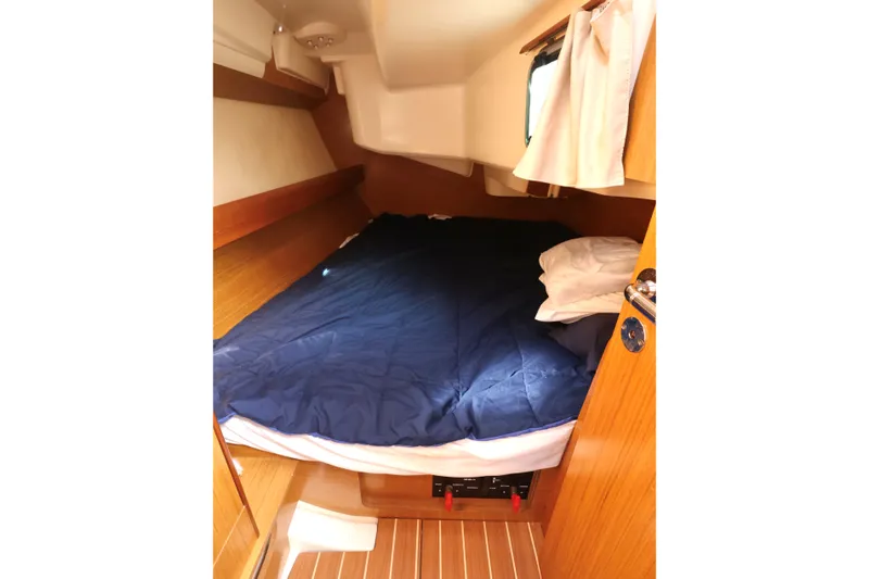 Slide: The Image of Cozy cabin interior of 2008 Jeanneau Sun Odyssey 36i sailboat with bed and wooden finish. - 18