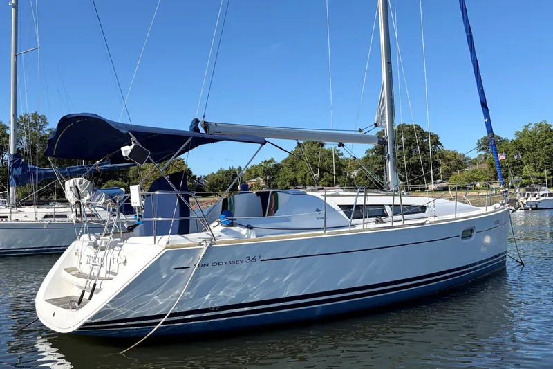 Slide: The Image of 2008 Jeanneau Sun Odyssey 36i sailboat docked in a serene marina setting. - 1
