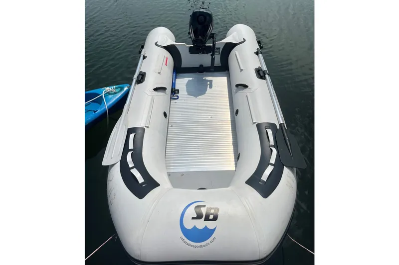 Slide: The Image of Inflatable boat with motor on water, near a blue kayak. Jeanneau Sun Odyssey 36i, 2008. - 26