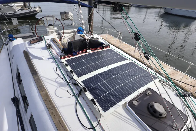 Slide: The Image of Sailboat Jeanneau Sun Odyssey 36i with solar panels on deck, docked at marina. - 4