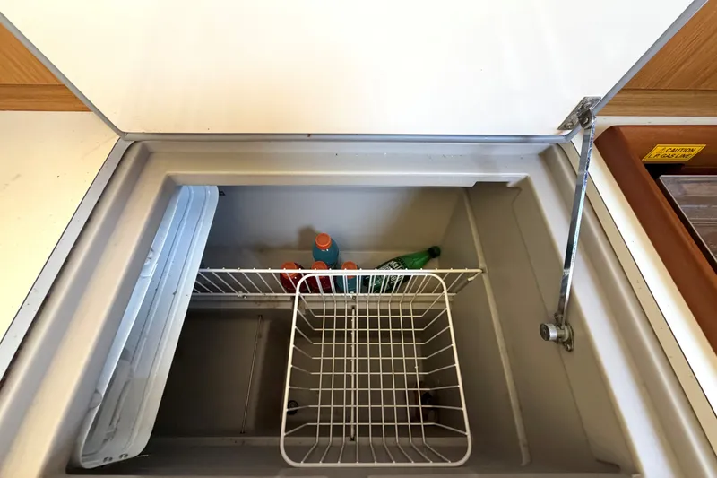 Slide: The Image of Open fridge on 2008 Jeanneau Sun Odyssey 36i yacht with drinks inside. - 15
