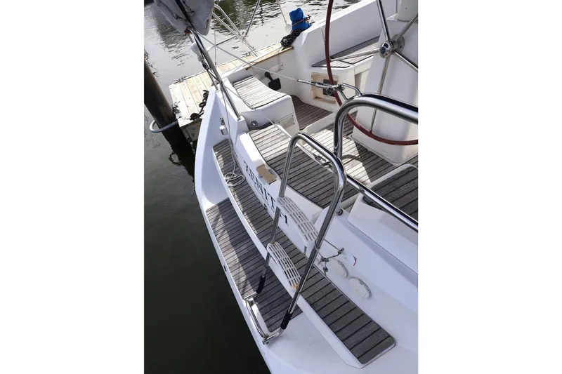 Slide: The Image of 2008 Jeanneau Sun Odyssey 36i sailboat deck with stainless steel railings and wooden steps. - 5