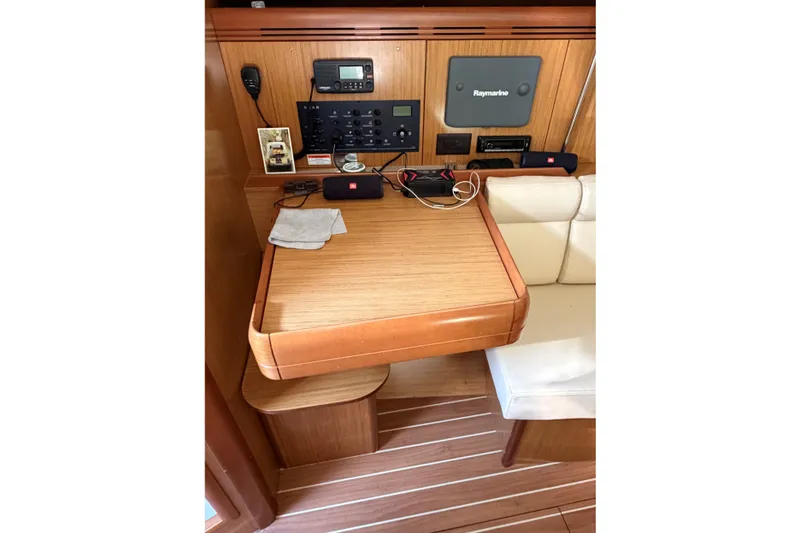 Slide: The Image of Navigation station on 2008 Jeanneau Sun Odyssey 36i yacht with control panel and seating. - 16