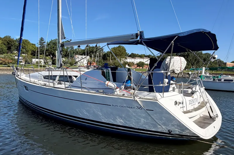 Slide: The Image of 2008 Jeanneau Sun Odyssey 36i sailboat docked in a serene marina setting. - 2