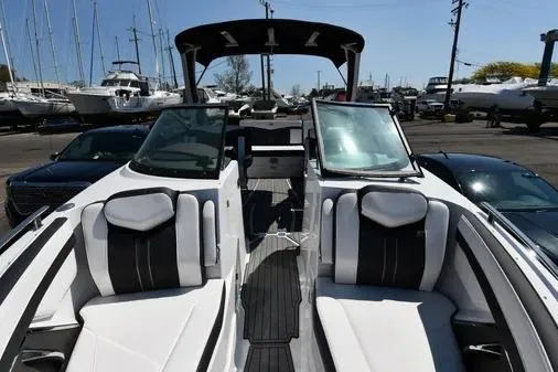 Slide: The Image of 2021 Monterey 278SS Super Sport boat with sleek seating and modern design in a marina setting. - 8