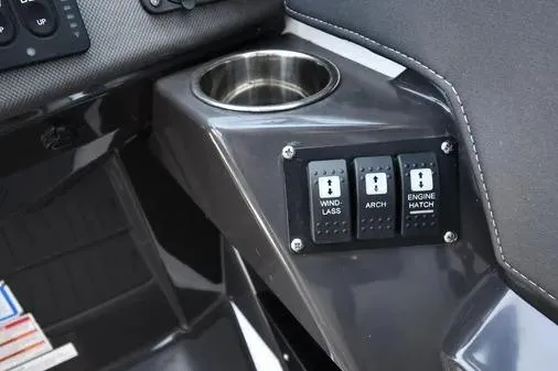 Slide: The Image of 2021 Monterey 278SS Super Sport boat console with cup holder and control switches. - 16